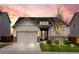 Charming home with a stone and siding exterior, solar panels, an attached garage, and a well-manicured lawn at 756 Ranchhand Dr, Berthoud, CO 80513