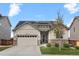 Charming home with a stone and siding exterior, solar panels, an attached garage, and a well-manicured lawn at 756 Ranchhand Dr, Berthoud, CO 80513