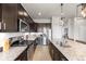 Bright kitchen with granite counters, stainless appliances, and ample cabinet space at 756 Ranchhand Dr, Berthoud, CO 80513