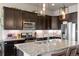 Modern kitchen boasts granite counters, sleek appliances, and a stylish tile backsplash at 756 Ranchhand Dr, Berthoud, CO 80513