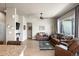 Spacious living room with hardwood floors, comfortable leather furniture, and a cozy fireplace at 756 Ranchhand Dr, Berthoud, CO 80513