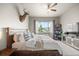 Bedroom featuring natural light, a ceiling fan, and a decorative deer head at 756 Ranchhand Dr, Berthoud, CO 80513