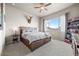 Comfortable bedroom with a large window, a ceiling fan, and neutral-toned walls at 756 Ranchhand Dr, Berthoud, CO 80513