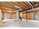 Unfinished basement featuring exposed wood ceilings, ductwork, concrete walls, and concrete floor at 3866 S King St, Denver, CO 80236