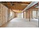 Unfinished basement with concrete walls and floor, exposed ceiling, and a small window at 3866 S King St, Denver, CO 80236