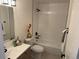 Bathroom features a tub with modern tile, a vanity with black hardware, and decorative accents at 3866 S King St, Denver, CO 80236