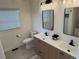 Bathroom features a double vanity with modern fixtures, quartz countertops, and tiled floors at 3866 S King St, Denver, CO 80236