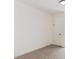 Neutral bedroom featuring carpet and a large white door with a black handle at 3866 S King St, Denver, CO 80236
