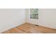 Bright bedroom featuring hardwood floors and a large window that lets in natural light at 3866 S King St, Denver, CO 80236