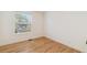 Bright bedroom featuring hardwood floors and a large window that lets in natural light at 3866 S King St, Denver, CO 80236