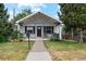 Charming single-story home with a cozy front porch and well-maintained lawn and landscaping at 3866 S King St, Denver, CO 80236