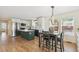 Stylish kitchen with modern appliances, a center island, and an adjacent dining area with stylish lighting at 3866 S King St, Denver, CO 80236