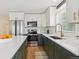 Bright kitchen featuring updated appliances, including stainless steel refrigerator and white countertops at 3866 S King St, Denver, CO 80236