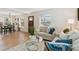 Inviting living room boasts hardwood floors, neutral-toned furniture, and plenty of natural light at 3866 S King St, Denver, CO 80236