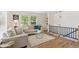 Bright living room with hardwood floors, a comfortable sofa, a glass coffee table, and large windows at 3866 S King St, Denver, CO 80236