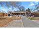 Expansive backyard featuring a covered patio, picnic table, and lush green space, perfect for outdoor gatherings at 61 S 17Th Ave Dr, Brighton, CO 80601