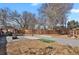 Lush backyard featuring a gazebo, fire pit, basketball court, and wood fencing, ideal for outdoor recreation at 61 S 17Th Ave Dr, Brighton, CO 80601