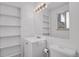 Bright bathroom features a vanity with built-in shelves and a large mirror at 61 S 17Th Ave Dr, Brighton, CO 80601