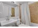 Bathroom features a tiled shower, large mirror, and pedestal sink at 61 S 17Th Ave Dr, Brighton, CO 80601