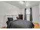 Comfortable bedroom features hardwood floors, a neutral color scheme, and bright natural light at 61 S 17Th Ave Dr, Brighton, CO 80601