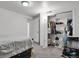 Carpeted bedroom featuring a closet with shelving, hanging storage, and a desk for a functional and organized space at 61 S 17Th Ave Dr, Brighton, CO 80601