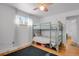 Bedroom with bunkbeds, ceiling fan, hardwood floors, and natural light from window at 61 S 17Th Ave Dr, Brighton, CO 80601