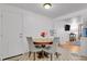 Cozy dining area with wood table, upholstered chairs, and convenient access to living room and kitchen at 61 S 17Th Ave Dr, Brighton, CO 80601