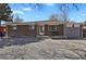 Well-kept brick home featuring gravel landscaping, a covered porch, and attached one-car garage at 61 S 17Th Ave Dr, Brighton, CO 80601