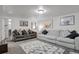 A cozy living room featuring two sofas, decorative pillows, and eye-catching highland cow art at 61 S 17Th Ave Dr, Brighton, CO 80601