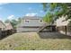 Backyard view of the house with a gray exterior and wooden deck at 19954 E Dartmouth Ave, Aurora, CO 80013