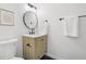 Modern bathroom with stylish vanity, round mirror, and sleek fixtures at 19954 E Dartmouth Ave, Aurora, CO 80013