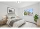 Bright bedroom with a large window, neutral decor, and stylish furnishings creates a cozy and inviting atmosphere at 19954 E Dartmouth Ave, Aurora, CO 80013