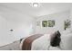 Bright bedroom features a window view, bench, and modern furnishings for a relaxing retreat at 19954 E Dartmouth Ave, Aurora, CO 80013