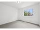 Spacious bedroom with large window, neutral carpet, and crisp white walls at 19954 E Dartmouth Ave, Aurora, CO 80013