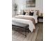 Bright bedroom features a window view, bench, and modern furnishings for a relaxing retreat at 19954 E Dartmouth Ave, Aurora, CO 80013