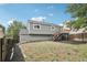 Back exterior view of home with a deck and steps at 19954 E Dartmouth Ave, Aurora, CO 80013