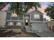 Charming two-story home with a well-manicured front yard and attached garage, illuminated by the soft glow of twilight at 19954 E Dartmouth Ave, Aurora, CO 80013