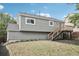 Rear exterior view of the house showcases a wooden deck and yard at 19954 E Dartmouth Ave, Aurora, CO 80013