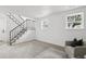 Staircase leads to the living room with large windows and a comfortable seating area at 19954 E Dartmouth Ave, Aurora, CO 80013