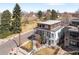 Aerial view of a modern home with balconies, a manicured lawn, and mature trees at 2600 S Sherman St, Denver, CO 80210