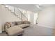 Finished basement with a sectional sofa, stairs, and carpeted floors at 2600 S Sherman St, Denver, CO 80210