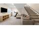 Finished basement with a sectional couch, treadmill, and carpeted floors at 2600 S Sherman St, Denver, CO 80210