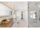Bright bathroom featuring a soaking tub, glass shower, and double vanity with quartz countertops at 2600 S Sherman St, Denver, CO 80210