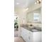 Bright bathroom featuring a large mirror and double vanity with quartz countertops and modern fixtures at 2600 S Sherman St, Denver, CO 80210