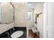 Powder room with dark countertops, designer mirror, and coat rack at 2600 S Sherman St, Denver, CO 80210