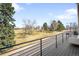 Outdoor deck with railing and view of trees and street at 2600 S Sherman St, Denver, CO 80210