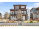 Modern two-story duplex featuring a brick facade, balconies, and manicured front yard at 2600 S Sherman St, Denver, CO 80210