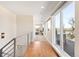 Bright hallway with hardwood floors, large windows, and metal railings leading to a deck at 2600 S Sherman St, Denver, CO 80210
