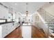 Open kitchen with stainless steel appliances, island with cooktop, and hardwood flooring at 2600 S Sherman St, Denver, CO 80210