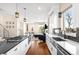 Open kitchen with stainless appliances, white cabinets, and seamless access to the living space at 2600 S Sherman St, Denver, CO 80210